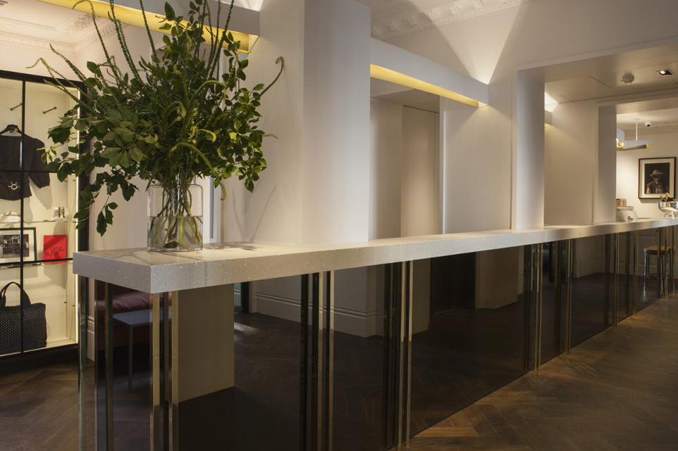 dimly lit hotel reception area with large floral arrangement