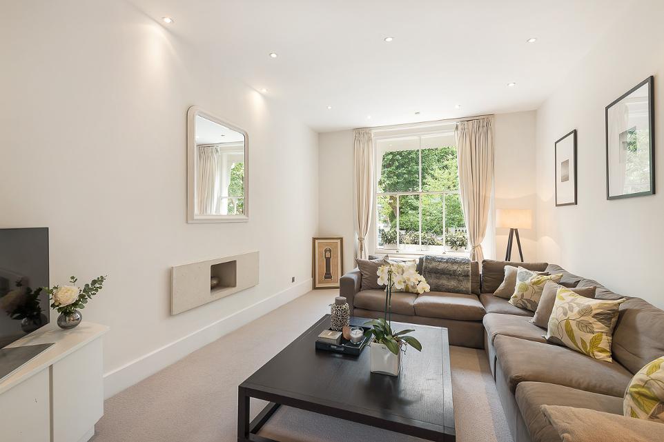 spacious living room area with spotlights, settee and fireplace