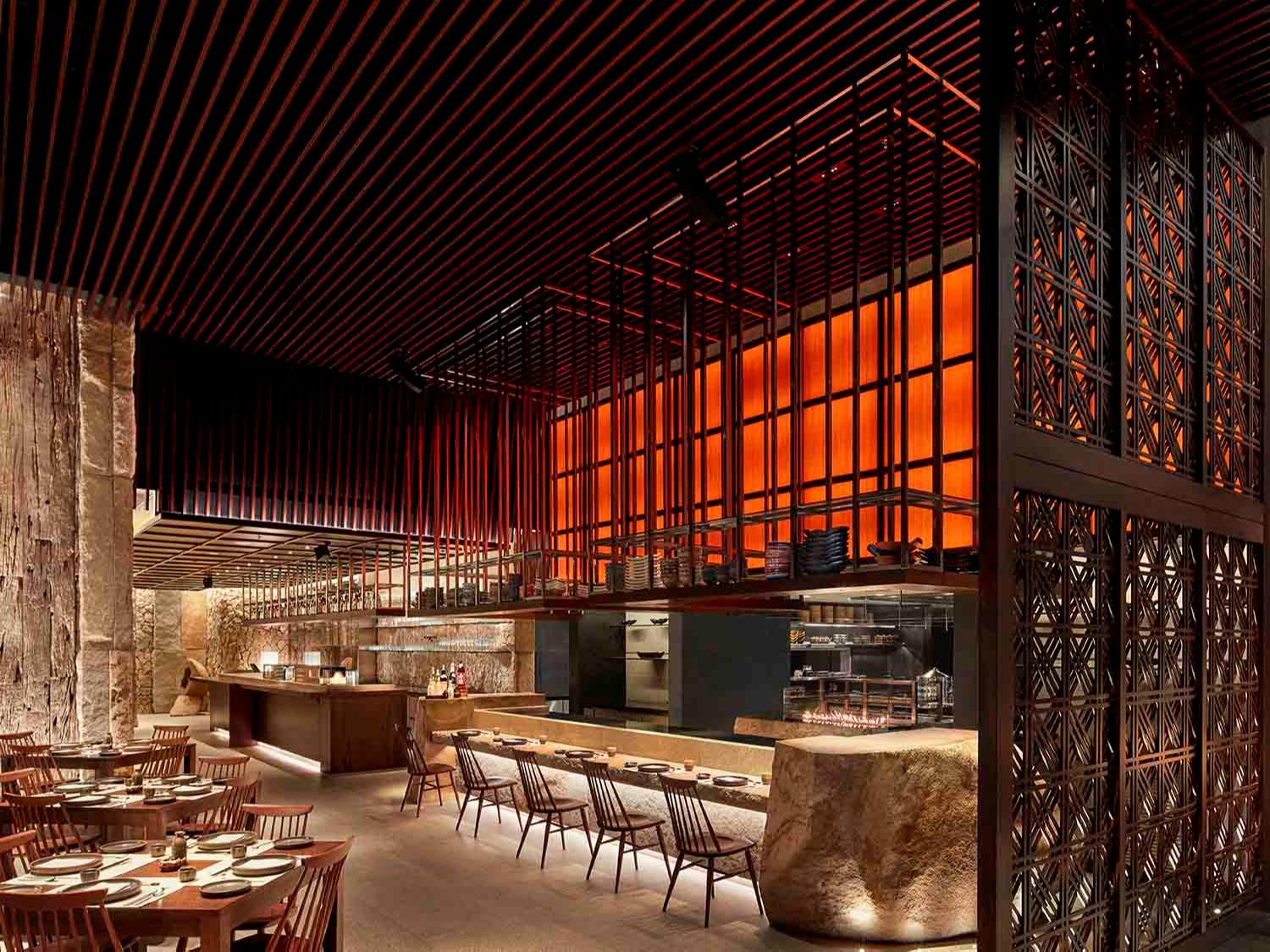 Restaurant area with multiple uplighters and downlights creating dimly-lit, cosy lighting
