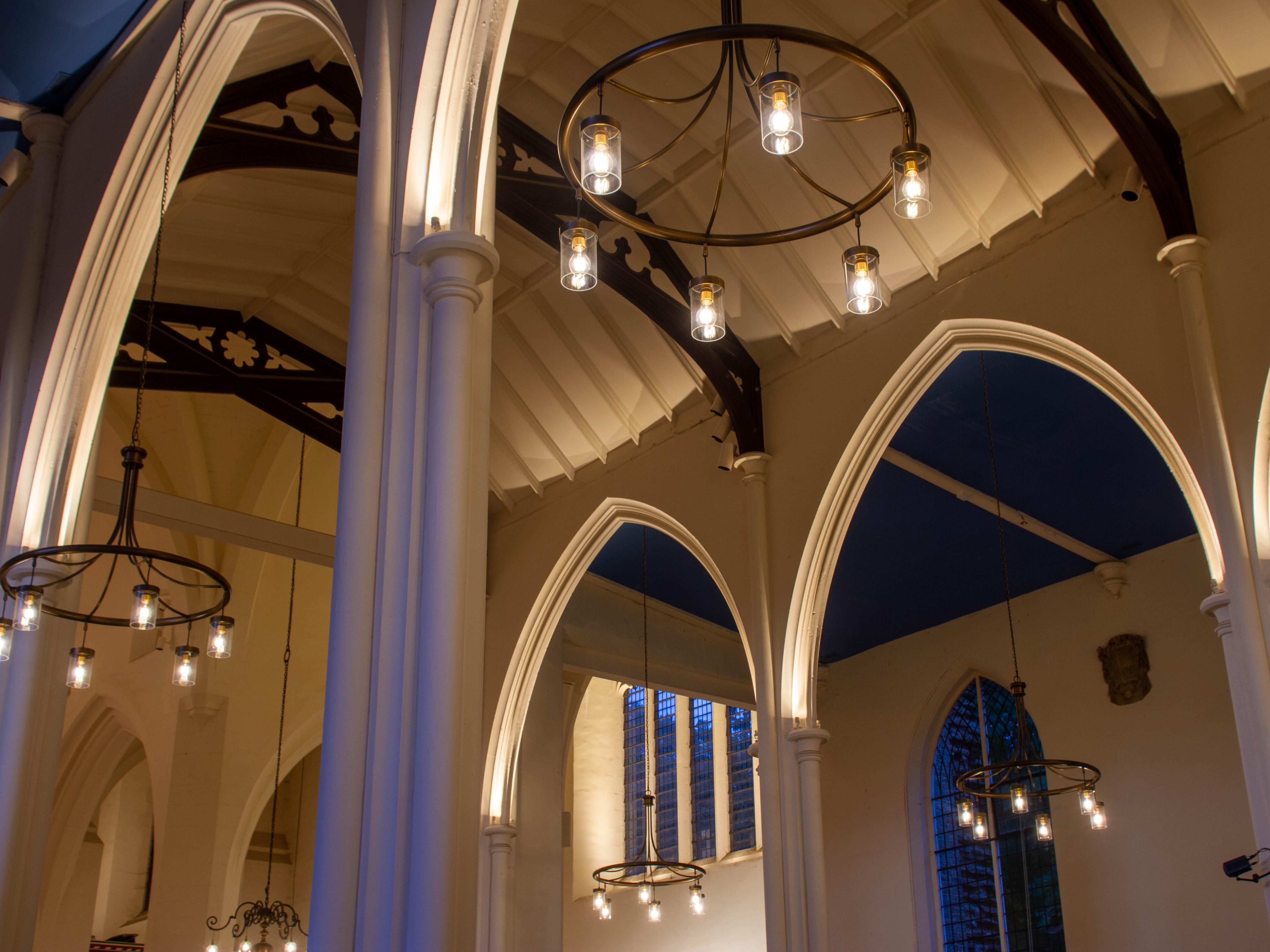 High ceilings in a gothic style church with antique chandeliers