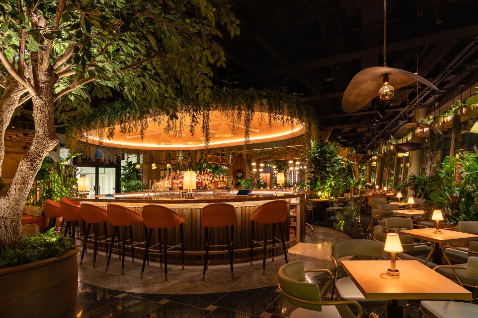 Cocktail bar with stunning interior design featuring ambient lights and rainforest theme
