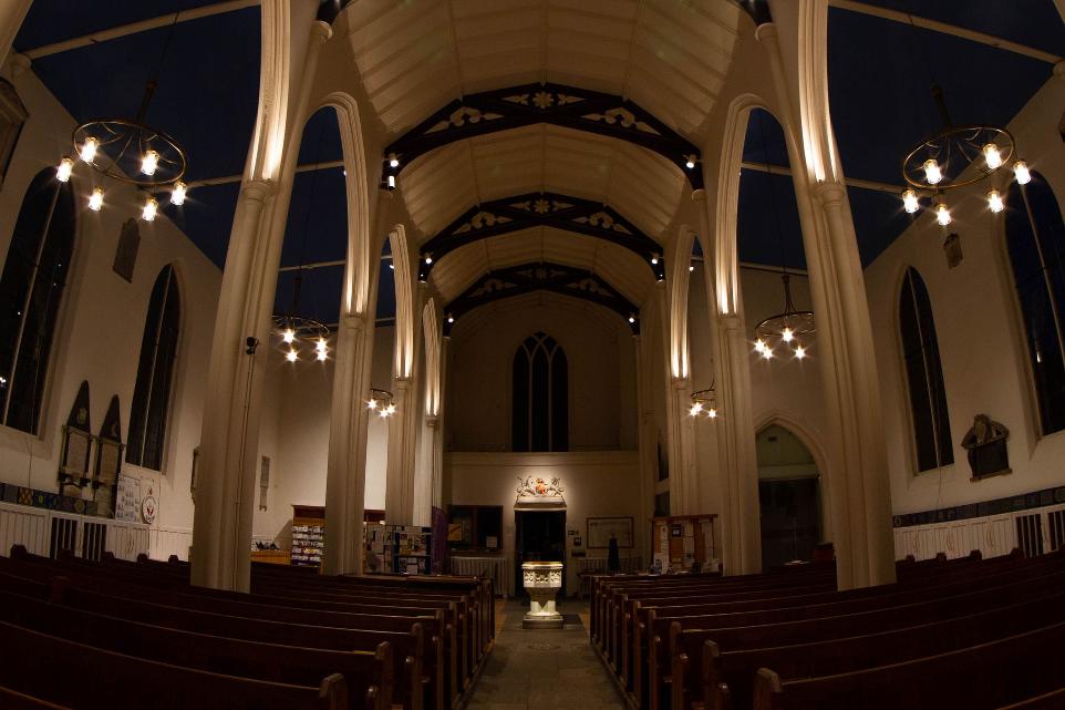church altar and pews with candle like lighting
